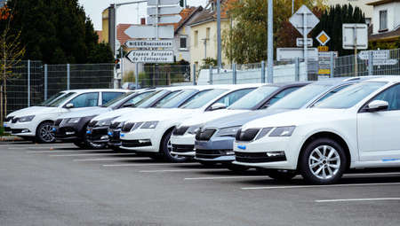 Strasbourg, France - Nov 7 2017: Row of new Skoda Superb white limousines cars for sale large stock in wide parking lot - French car dealer inventoryのeditorial素材