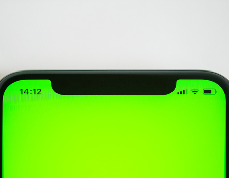Smartphone detail with chroma green screen and icons for the current hour, battery charge wi-fi and network lte signalの写真素材