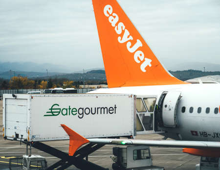 Basel, Switzerland - Nov 11, 2017: Above view of food being loaded by workers to Airbus A320-214 operated by EasyJet airlines GateGourmet airline catering containerのeditorial素材