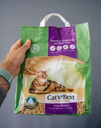 Paris, France - Apr 28, 2018: Man POV hold in hand a package of Cat's Best Smart Pellets for ecological pet litterのeditorial素材