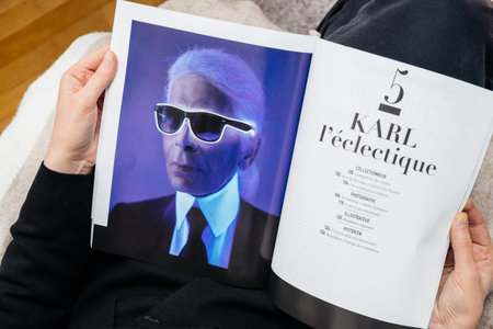 Paris, France - Feb 23, 2019: Woman reading French Le Figaro magazine covering Karl Lagerfeld death,...