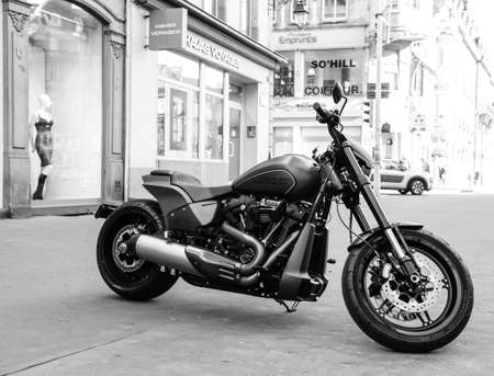 Strasbourg, France - Feb 16, 2018: Parked in the city brand new Harley Davidson bike motorbike with shops and buildings in the background black and whiteのeditorial素材