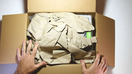 Paris, France - Feb 20, 2019: View from above POV man unboxing latest Nvidia Quadro RTX 8000 workstation professional video card GPU from the cardboard Amazon Parcel boxのeditorial素材