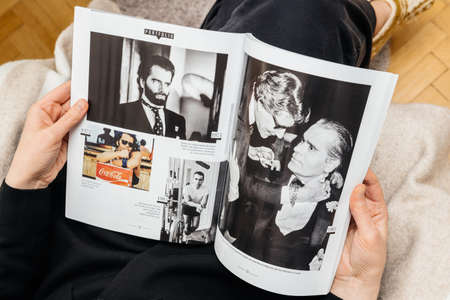 Paris, France - Feb 23, 2019: Woman reading French magazine covering Karl Lagerfeld death, iconic fashion designer died aged 85 - photo with Yves Saint Laurentのeditorial素材