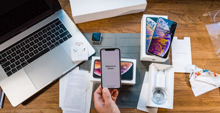 PARIS, FRANCE - SEPTEMBER 21, 2018: Apple fan boy unboxing latest new Apple Iphone Xs Max and Xs flagship smartphone mobile phone model from Apple Computers accesories unboxing and testing of the chargerのeditorial素材