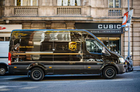 Barcelona, Spain - Oct 14, 2017: Fast UPS United PArcel Service delivery van on central Barcelona street delivering parcels with shop in background global business distributionのeditorial素材