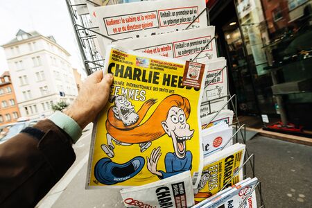 Paris, France - Mar 12, 2019: Charlie Hebdo with cover featuring caricature dedicated to International Women Dayのeditorial素材