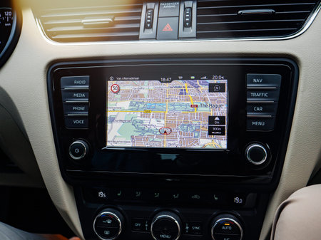 THE HAGUE, NETHERLANDS - AUG 19, 2018: Modern GPS tablet computer on the wide dashboard of luxury...