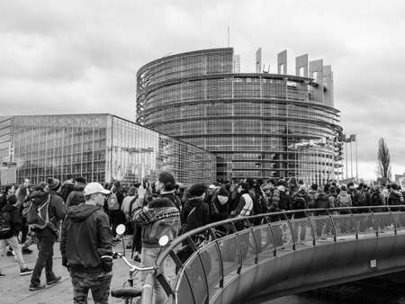 STRASBOURG, FRANCE - MAR 15 2019: Protesters at the bridge near European Parliament during demonstrations against climate change global movement Fridays for Future started by schoolgirl Greta Thunbergのeditorial素材