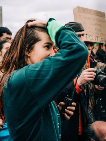 STRASBOURG, FRANCE - MAR 15, 2019: Young girl seen through security fence near European Parliament during demonstrations against climate change global movement Fridays for Futureのeditorial素材