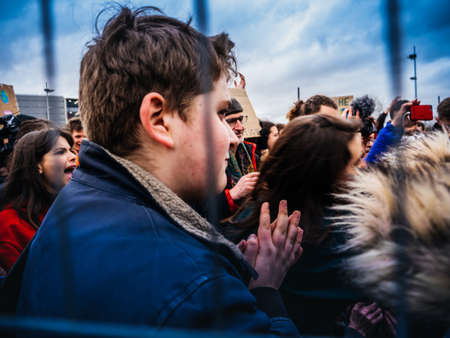 STRASBOURG, FRANCE - MAR 15, 2019: Protesters seen through security fence near European Parliament during demonstrations against climate change global movement Fridays for Futureのeditorial素材
