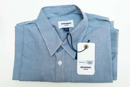 Paris, France - Jul 12, 2018: new business blue Medwinds Camper striped shirt isolated on white backgroundのeditorial素材