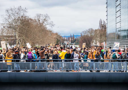 STRASBOURG, FRANCE - MAR 15, 2019: Protesters on bridge near European Parliament during demonstrations against climate change global movement Fridays for Future started by Swedish schoolgirl Greta Thunbergのeditorial素材