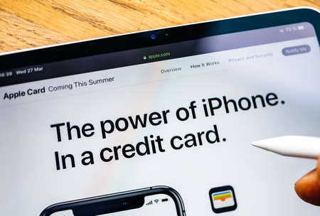 Paris, France - Mar 27, 2019: Man POV at iPad Pro tablet reading on Apple.com website about new Apple Card the power of iphone in a credit cardのeditorial素材