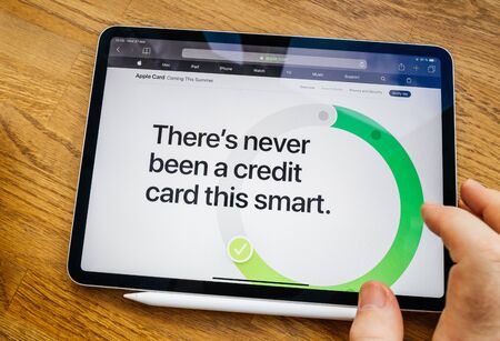Paris, France - Mar 27, 2019: Man POV at iPad Pro tablet reading on Apple.com website about new Apple Card - there's never been a credit card this smartのeditorial素材