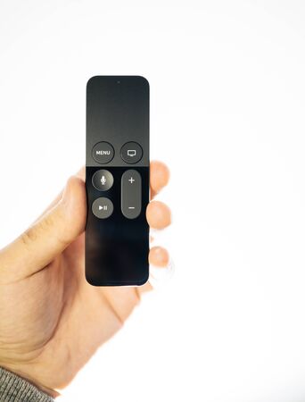 Paris, France - 25 Mar 2019: Modern sparkle white background with front view remote control of Apple TV 4k player with Siri assistant browsing Apple TV plus subscriptionのeditorial素材