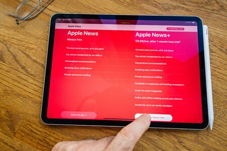 Paris, France - Mar 27, 2019: Apple News vs Plus a service which gives users access to more than 300 magazines for a monthly payment - price comparison and featuresのeditorial素材