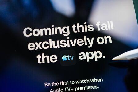 Paris, France - Mar 27, 2019: POV man holding Apple Pencil over the new iPad Pro Apple TV Plus streaming service coming this fall exclusively in Apple TV appのeditorial素材