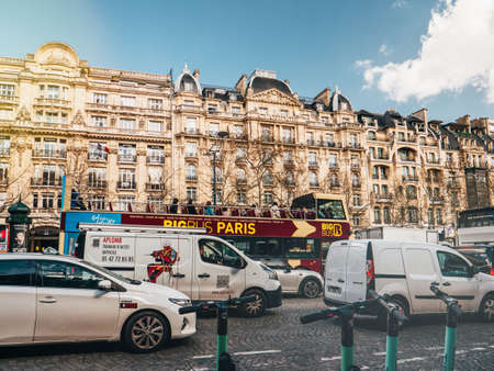 Paris, France - Mar 19, 2019: Paris cityscape scene with beautiful haussmannian buildings in background , traffic jam and big bus Paris sightseeing tours with tourists insideのeditorial素材