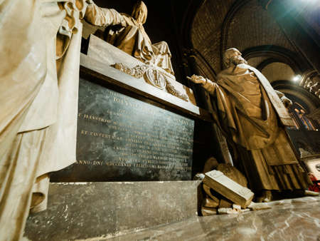 Paris, France - Apr 15, 2018: Tomb inside Notre-Dame Cathedral with toursit a few minutes before the cathedrals fire started and spire and roof collapsed with significant damageのeditorial素材