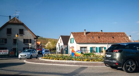 Alsace, France - Apr 19, 2019: Easter decoration on roundabout with Rabbit character painting egg with gray pride flag coloursのeditorial素材