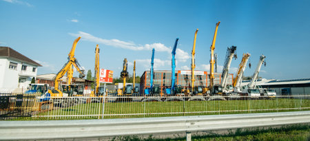 Strasbourg, France - Apr 19, 2019: Side view of large fleet of multiple tall telescopic platforms in...