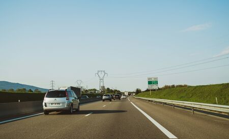 Strasbourg, France - Apr 19, 2019: Driver POV at the front driving Citroen C4 car van on French autoroute highway with clear blue sky and large powerlines crossing the highwayのeditorial素材