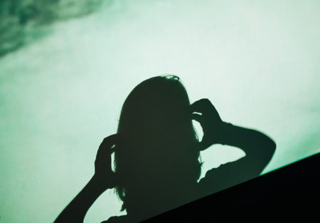 Abstract background shadow silhouette of female woman screaming scared holding head with hands on...