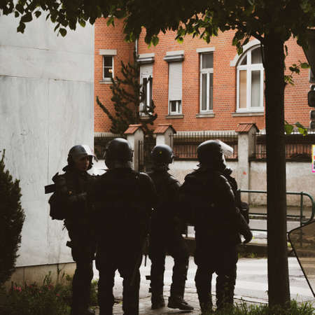 Strasbourg, France - Apr 28, 2019: Squadron of four police gerdarms officers secruing entrance to Rue Rene Schickele after altercations with Yellow Vests Gilets jaunesのeditorial素材