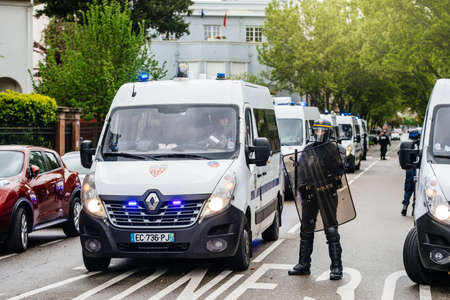 Strasbourg, France - Apr 28, 2019: Police officers and Renault vans securing street Rue Schweighaeuser in Strasbourg during Yellow Vests Gilets Jaunes manifestation protestのeditorial素材