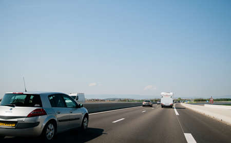 France - Apr 19, 2019: Light traffic on French highway perspective view at the long autoroute to French Vosges mountains Renault Megane and RV van in frontのeditorial素材