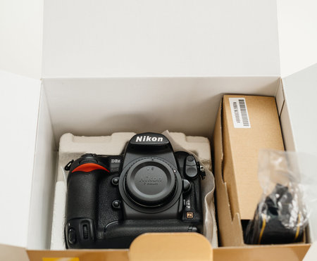 Paris, France - Feb 28, 2017: Directly above view of cardboard unboxing with new professional Nikon...