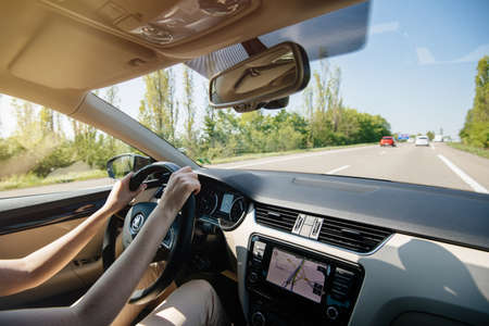 France - Apr 19, 2019: Relaxed woman driving Skoda luxury estate car with turned on GPS guidance on the dashboard light traffic in French highway autorouteのeditorial素材