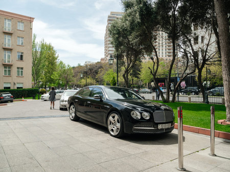 Baku, Azerbaijan - May 2, 2019: Luxury Bentley black car parked in front of Hyatt hotel in central...
