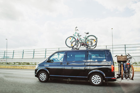 Netherlands - Aug 17, 2018: Gray Volkswagen Camper Van Bulli edition with two bicycles on the roof driving fast on Dutch highwayのeditorial素材
