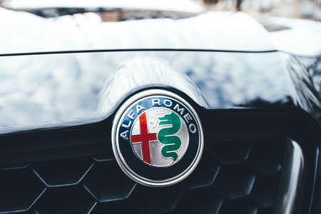 Paris, France - Feb 19, 2017: Front view of Alfa Romeo logotype with red cross and dragon on the blue carのeditorial素材