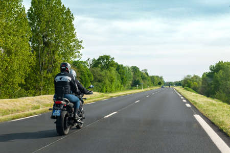 France - May 7, 2016: Team of motorcyclists driving fast on the dedicated lane on the almost empty highway in Franceのeditorial素材