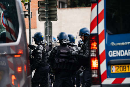 Strasbourg, France - Apr 28, 2019: Male officers rear view gendarmes near police vans Council of Europe during altercations protest of yellow vests gilets jaunesのeditorial素材