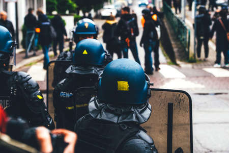 Strasbourg, France - Apr 28, 2019: Rear view of police officers looking at journalists reporting the Yellow Vests protests in Strasbourg a few meters from Council of Europe buildingのeditorial素材