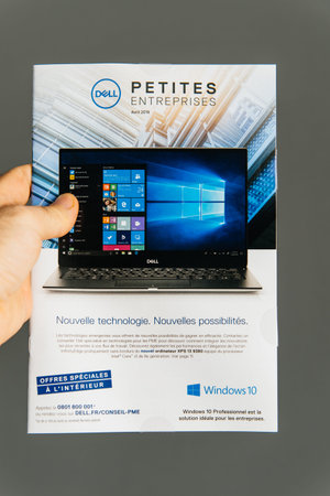 Paris, France - Apr 16, 2019: Man POV holding Dell Computers leaflet advertising distributed to...