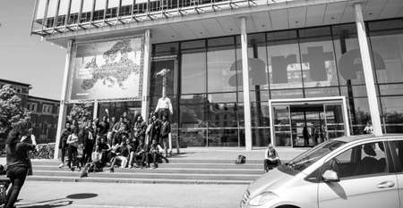 Strasbourg, France - May 23, 2019: Group of young funny black ethnicity childrens taking photo with the Homme Girafe statue in front of Arte Television headquarter - black and white imageのeditorial素材