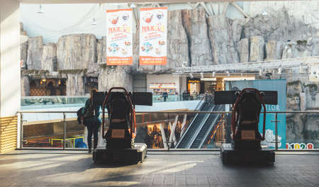 Bucharest, Romania - 2016: Two triple screen setup with steering wheel and pedals installed on racing chair inside Bucharest Mall - Racing gamesのeditorial素材