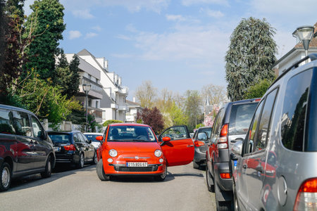 Strasbourg, France - Apr 4, 2017: Fiat 500 red car with open door blocking entire street in...