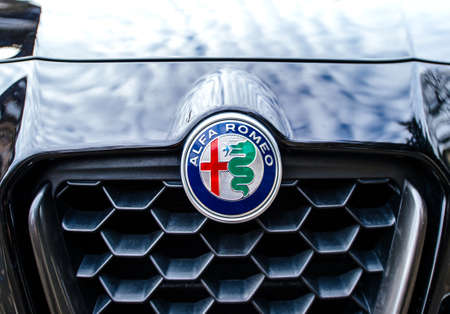 Paris, France - Feb 19, 2017: Close-up Front view of Alfa Romeo icon with red cross and dragon on the blue carのeditorial素材