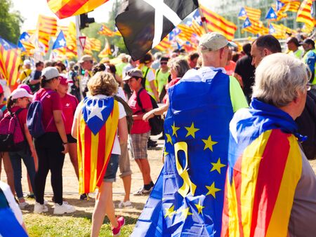 Strasbourg, France - Jul 2 2019: Man wearing EU and Estelada Catalan separatist flags demonstrate protest front of EU European Parliament against exclusion of three Catalan elected MEPsのeditorial素材