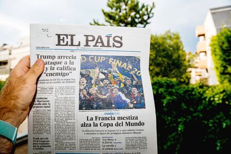 PARIS, FRANCE - JUL 16, 2018: Man reading El Pais newspaper announcing France champion title after French national football team won their FIFA World Cup 2018 final game against Croatia in Moscowのeditorial素材