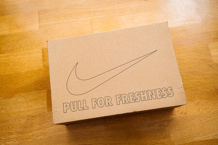 Paris France - Jul 7 2019: Man hand Above view unboxing unpacking sport running shoes equipment manufactured by Nike sportswear - Pull for freshness and logotypeのeditorial素材