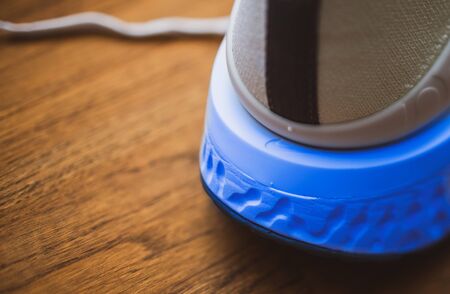 Paris, France - Jul 8, 2019: Rear view of part of new Nike Zoom Fly Flyknit 2 running shoes on wooden table - includes the NIke insignia on the rubber soleのeditorial素材