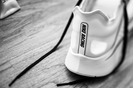 Paris, France - Jul 8, 2019: Side view of new Nike Zoom Fly SP Fast running shoes on wooden table - includes the Nike Racing insignia black and whiteのeditorial素材