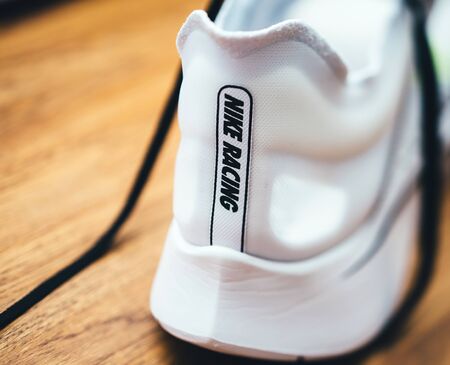 Paris, France - Jul 8, 2019: Macro rear view of new Nike Zoom Fly SP Fast running shoes on wooden table - includes the Nike Racing icon insigniaのeditorial素材